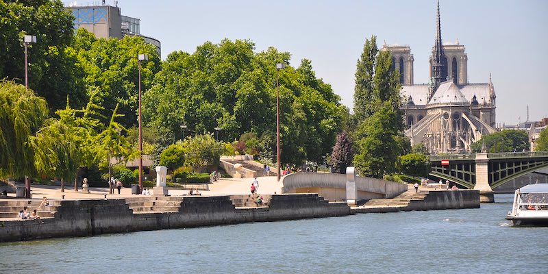 The Jardin Tino Rossi in Paris with Notre Dame in the background, seen from the River Seine