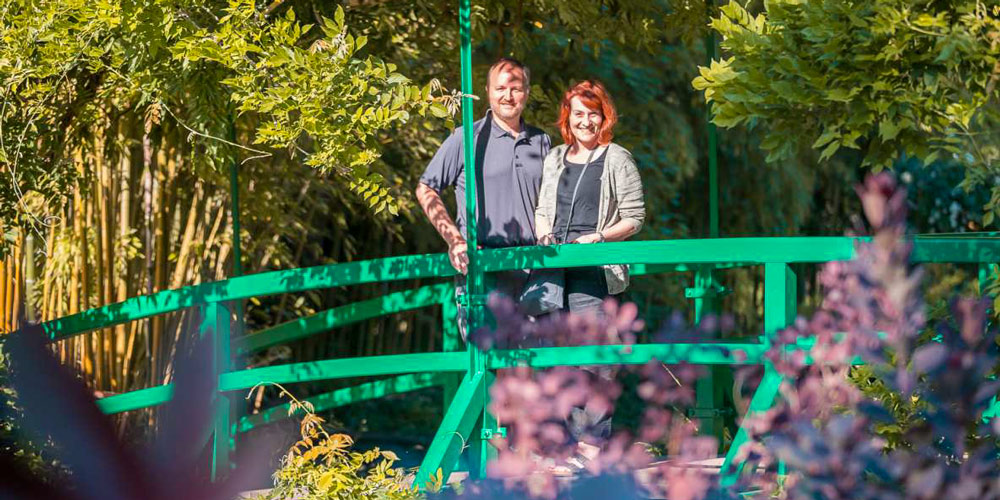 A couple on one of the famous Japanese bridges of Monet's gardens