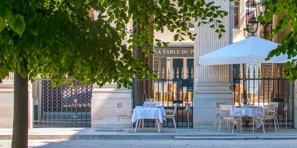 Palais Royal restaurant tables set up in the garden of the palais