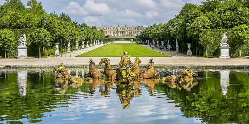 In the gardens of Versailles, the chateau in the distance