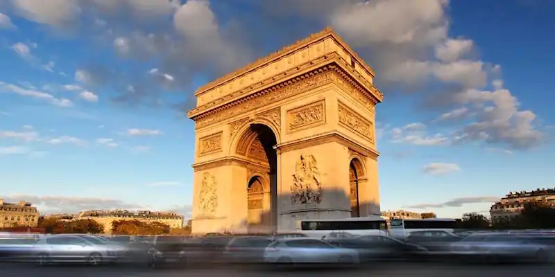 The Arc de Triomphe, located on a busy traffic circle