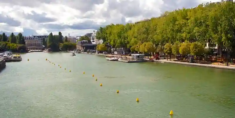 Bassin de la Villette with boats and tree-lined quays in the 19th Arrondissement of Paris