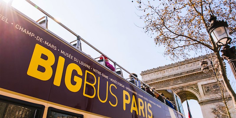 Hop-on bus passengers get  up close and personal with the Arc de Triomphe