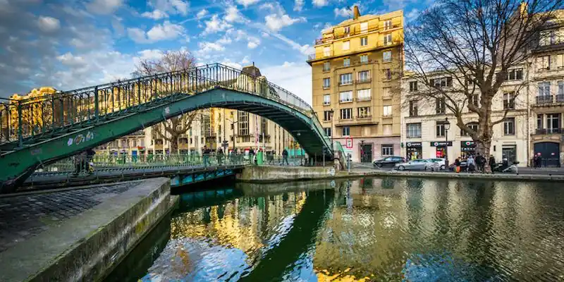An arched bridge spans Canal St Martin