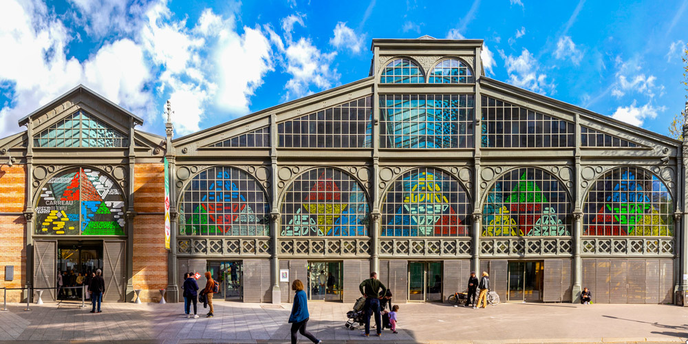 The front of the Carreau du Temple with its windows colorfully decorated