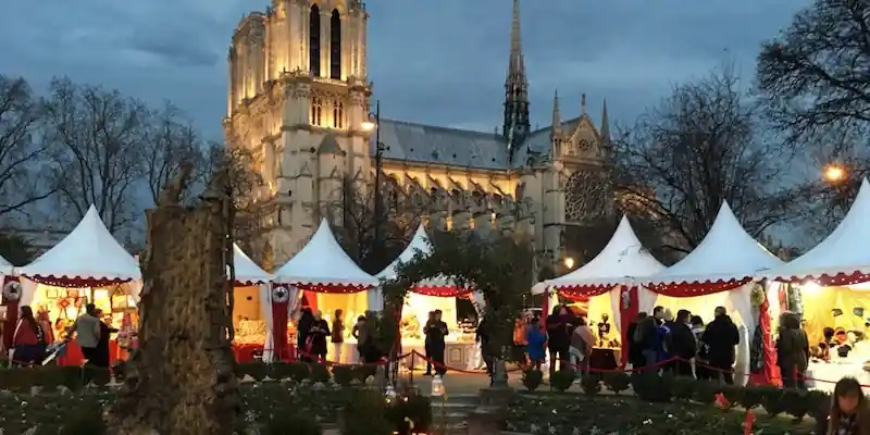 Christmas market chalets in Square René Viviani beside Notre-Dame in Paris
