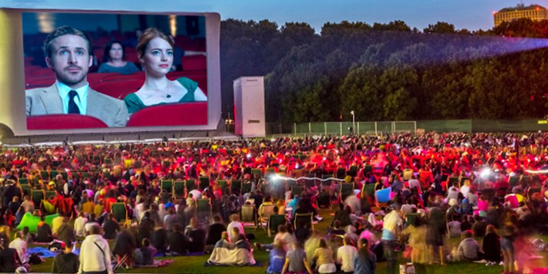 At La Villette Parisians sit in comfortable chairs watching La-La Land during Cinema En Plein Air