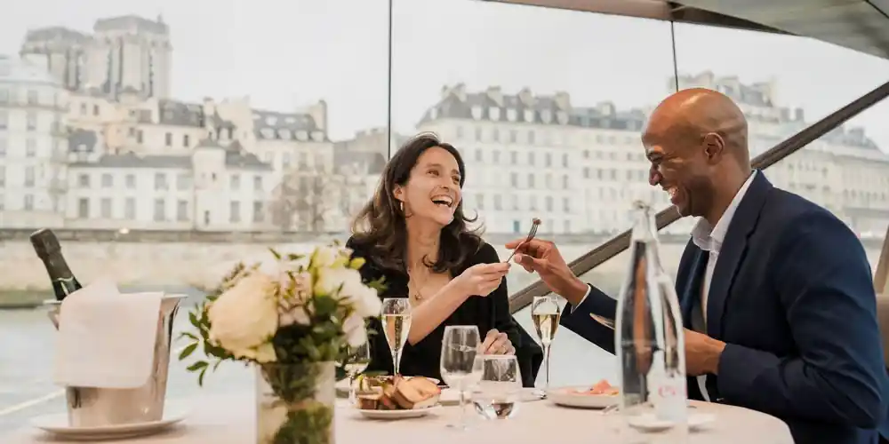 A Bateaux Mouches Dinner Cruise boat sails beneath Notre Dame in Paris