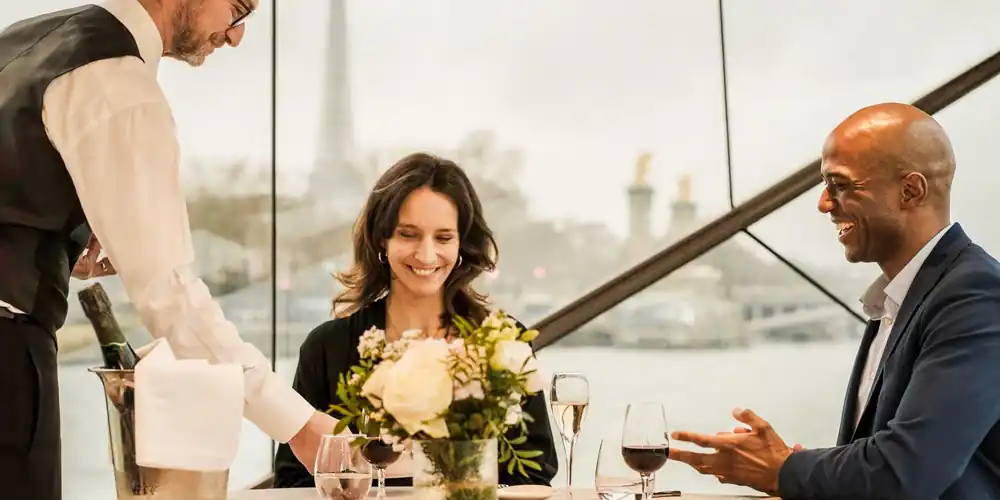 A couple enjoys and eraly evening dinner cruise in Paris