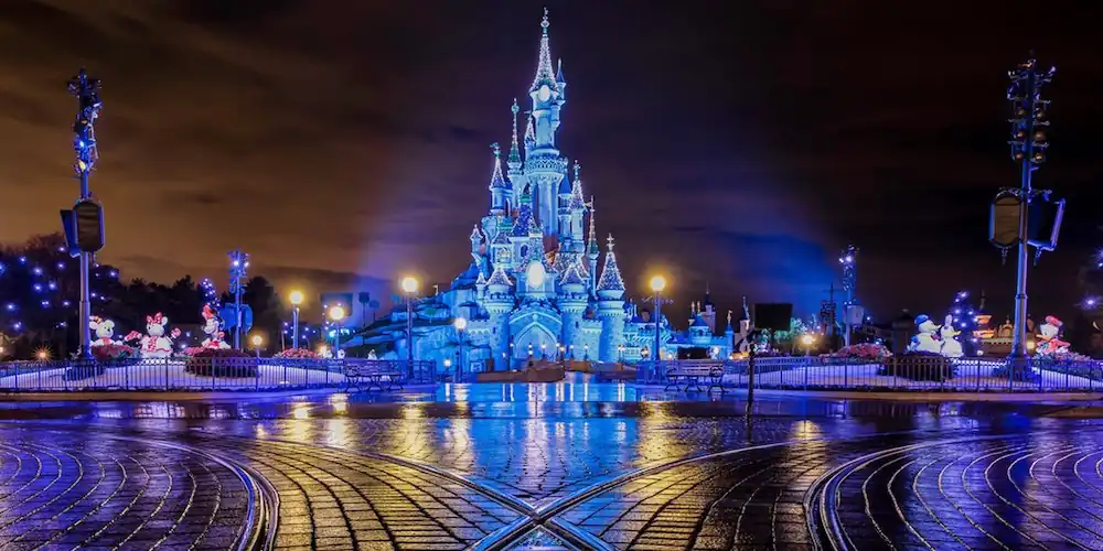 Disneyland Paris Magic Castle at night in a blue tone