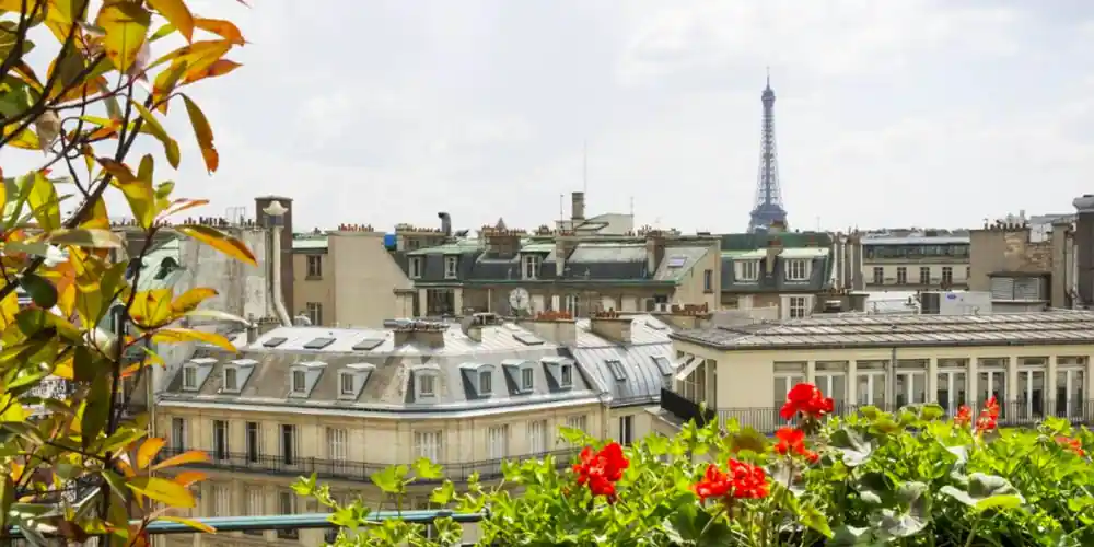 A woman views Paris from a river boat during a Bateaux Parisiens Dinner Cruise