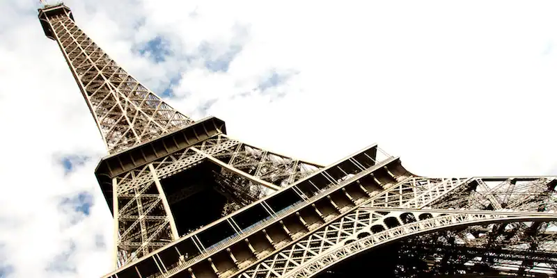 Looking up through the ironwork and visitor levels of the Eiffel Tower