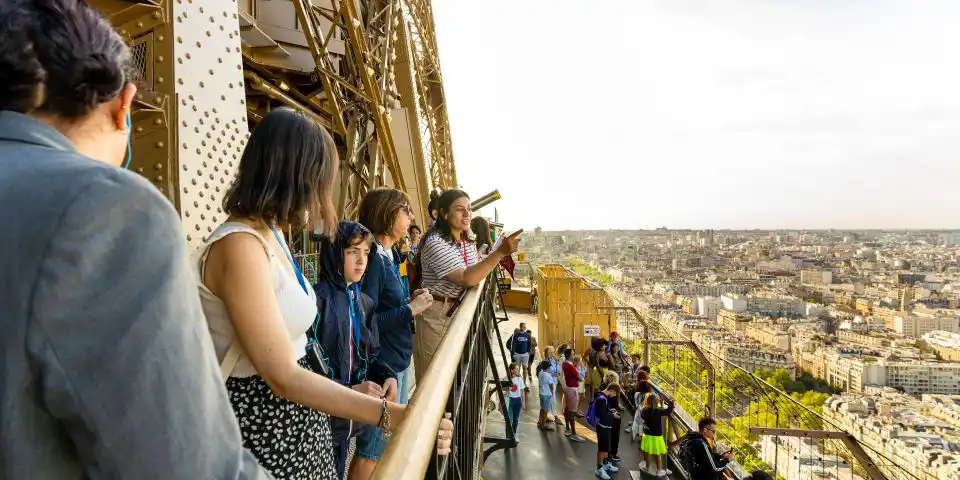 A guided tour on the Eiffel Tower, with Paris stretched out below