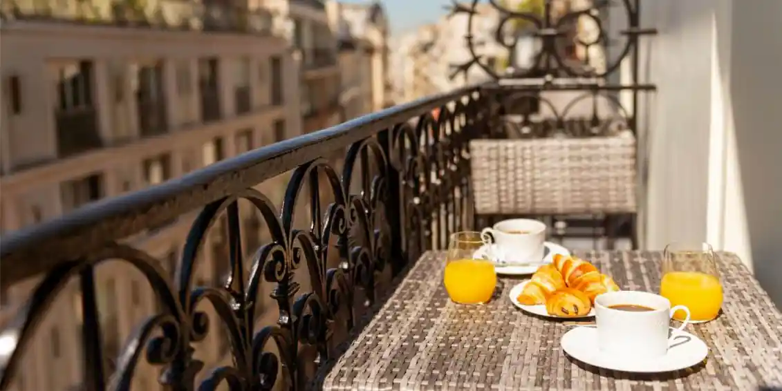 Breakfast on the balcony of a guest room at Le Milie Rose in Paris