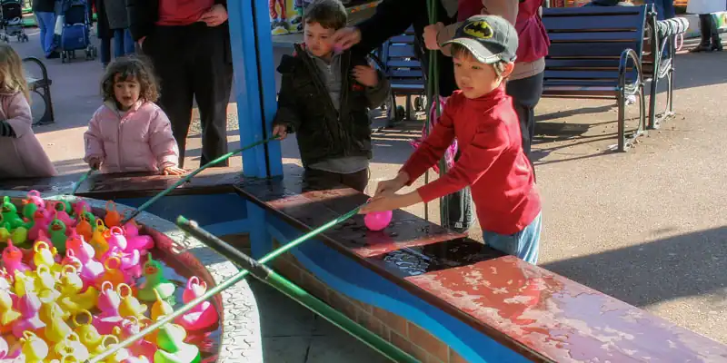 Alexandre fishing for rubber ducks at the Jardin d'Acclimatation