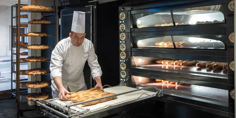A boulanger at work at the ovens in La Grande Epicerie de Paris, photo LVHM
