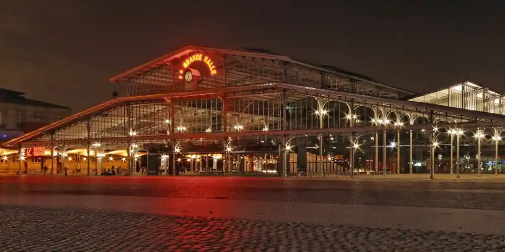 Grande Halle de la Villette illuminated at night in Paris