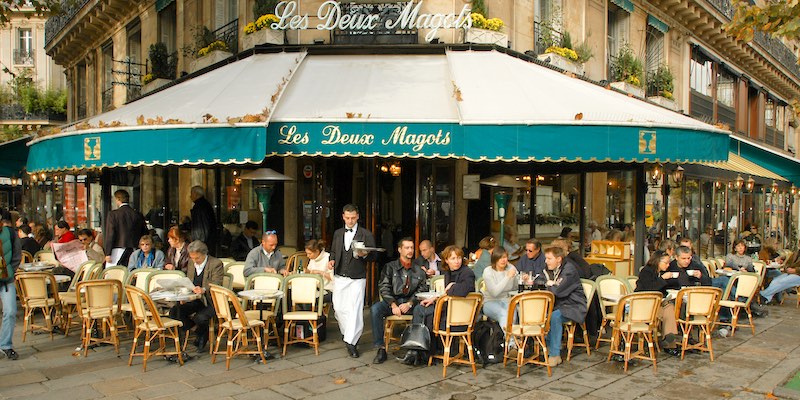 Diners spill out onto the sidewalks at Les Deux Magots
