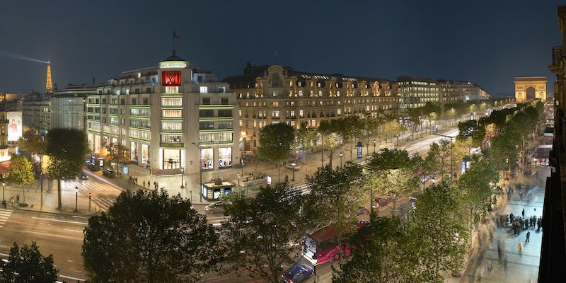 Champs Elysees showing the Louis Vuitton flagship store and the Arc de Triomphe at the end