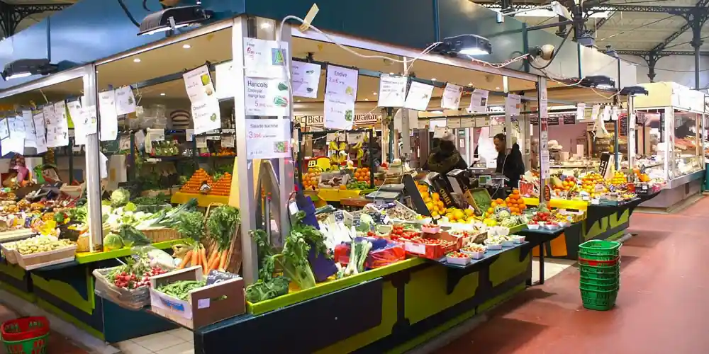 Produce stalls inside Marché Saint-Quentin in Paris