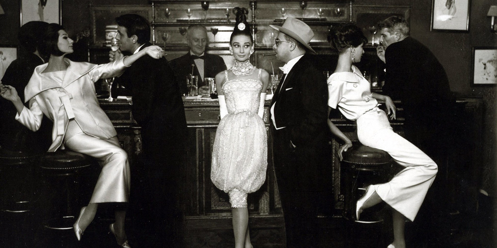 Aubrey Hepburn with Art Buchwald at Maxim's Paris Bar in 1959, by Richard Avedon for Harper's Bazaar
