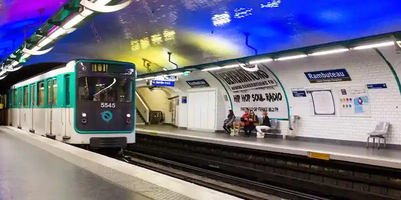 Paris Metro train arriving at a station platform