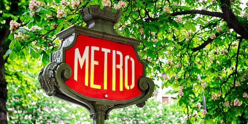 Paris Metro sign on a leafy street