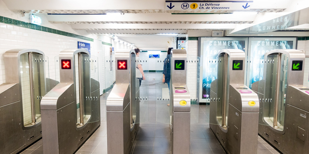 Entry gates at Metro Station Palais Royal showing the purple tap pads