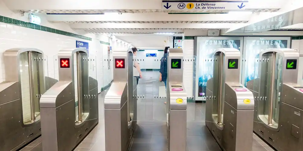 Entry gates at Metro Station Palais Royal showing the purple tap pads