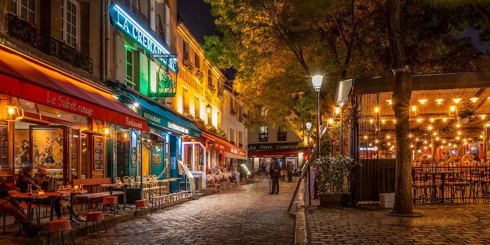 he streets of Montmartre at night, photo Wikimedia by Pierre Blache