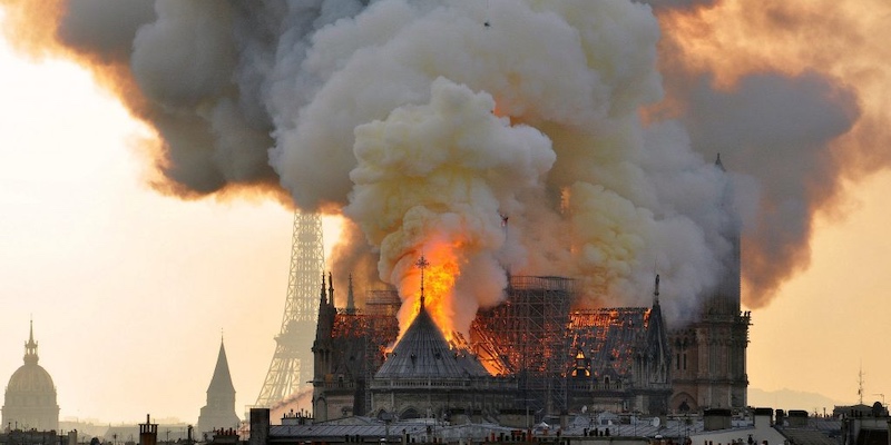 The fire at Notre Dame April 19, 2019 with the Eiffel Tower in the distance