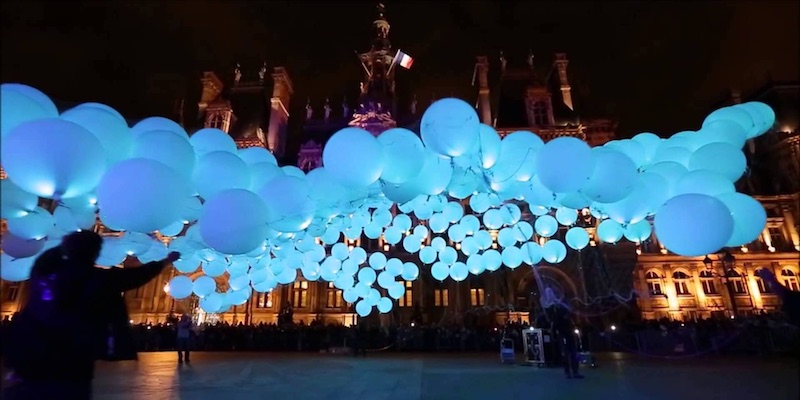 Illuminated blue balloons fill the night on the plaza in from the the Hotel de Ville as a part of Nuit Blanche