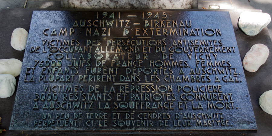 A simple stone with rasied brass letters makes up Auschwitz Memorial to the victims of Nazi extermination camps, photo by Mark Craft