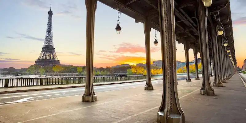 The iron columns of Pont de Bir-Hakeim support the Metro track and frame the Eiffel Tower