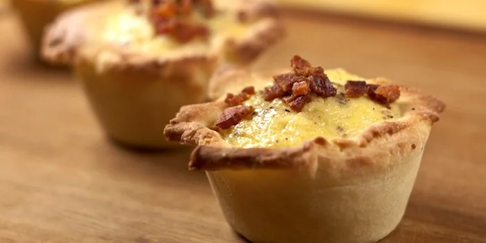 Individual Quiche Loraines with golden crust and bacon on top