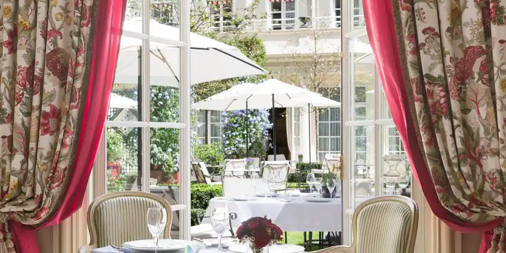 Dining room at Epicure overlooking the garden at Le Bristol Paris