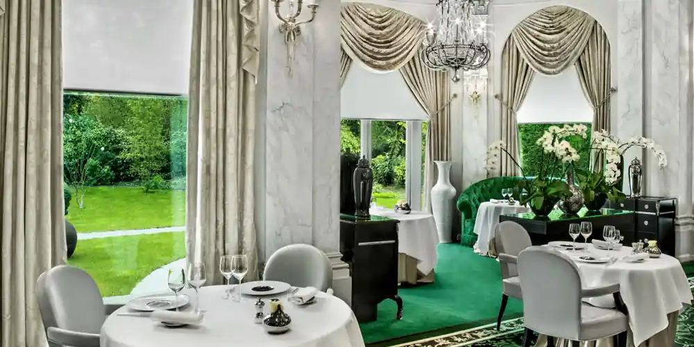 Dining room at Le Pré Catelan overlooking the gardens in the Bois de Boulogne