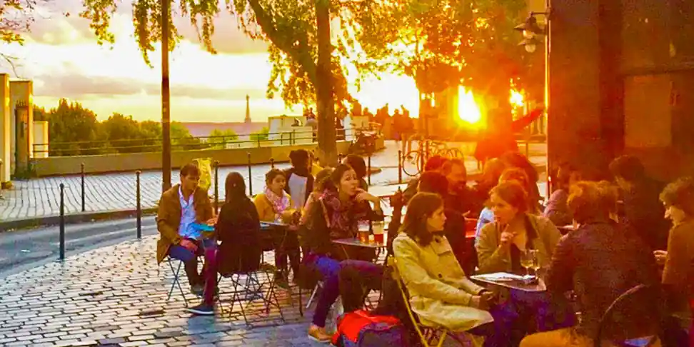 People at a café terrace in Belleville in the 20th Arrondissement at sunset