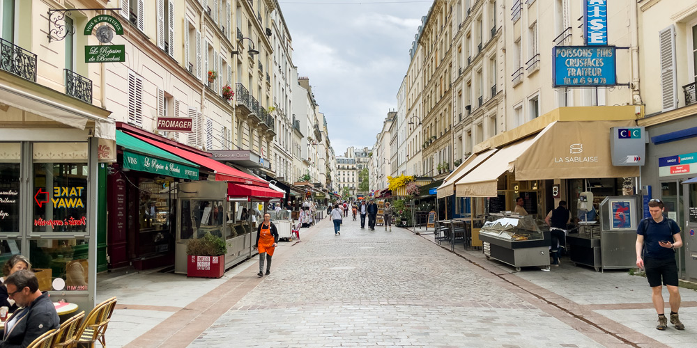 The cobblestone streets of Rue Cler and the shops lining it, photo by Mark Craft