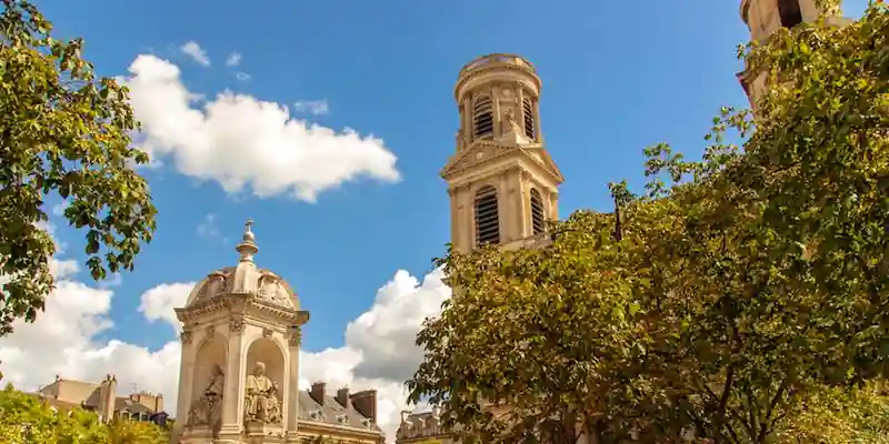 Église Saint-Sulpice towers framed by trees in Paris