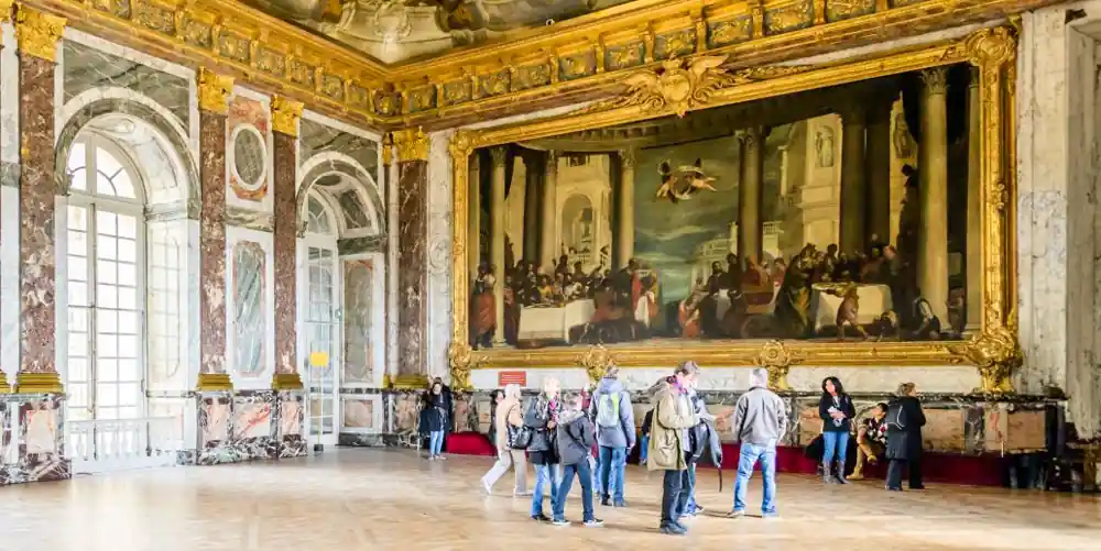 Visitors admiring the lavish interior of the Palace of Versailles