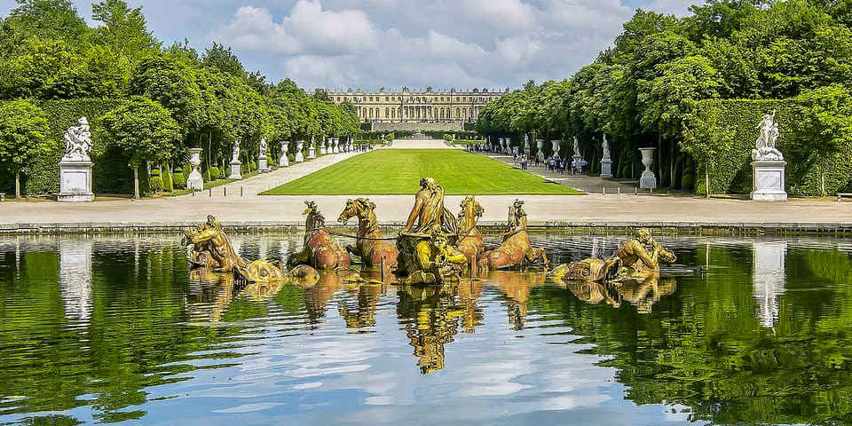 In the gardens of Versailles, the chateau in the distance