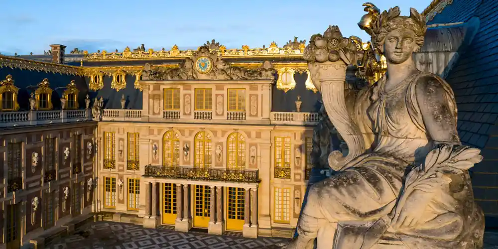 Statue overlooking the Palace of Versailles from the Cour Royale