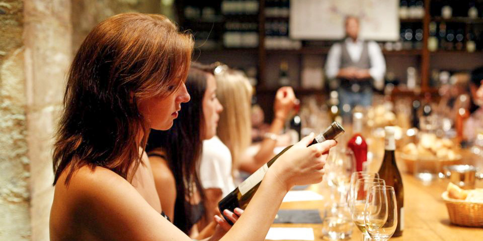 Participants at a long table during a Paris wine tasting